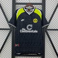 Features a black tonal-patterned body, neon yellow shoulder panels, short sleeves, a white-trimmed V-neck, the BVB 09 crest and contrasting Die Continentale sponsor detailing.
