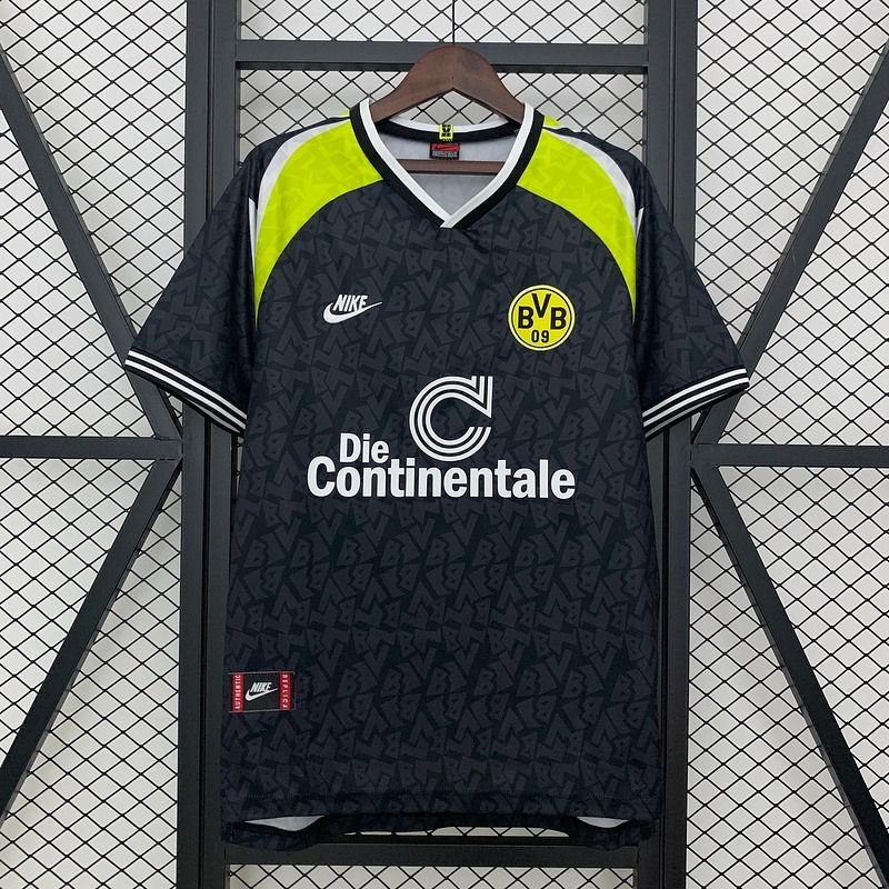 Features a black tonal-patterned body, neon yellow shoulder panels, short sleeves, a white-trimmed V-neck, the BVB 09 crest and contrasting Die Continentale sponsor detailing.
