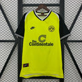 Borussia Dortmund retro home jersey, front view with a bright yellow body, black short sleeves, BVB 09 crest and Die Continentale sponsor.
