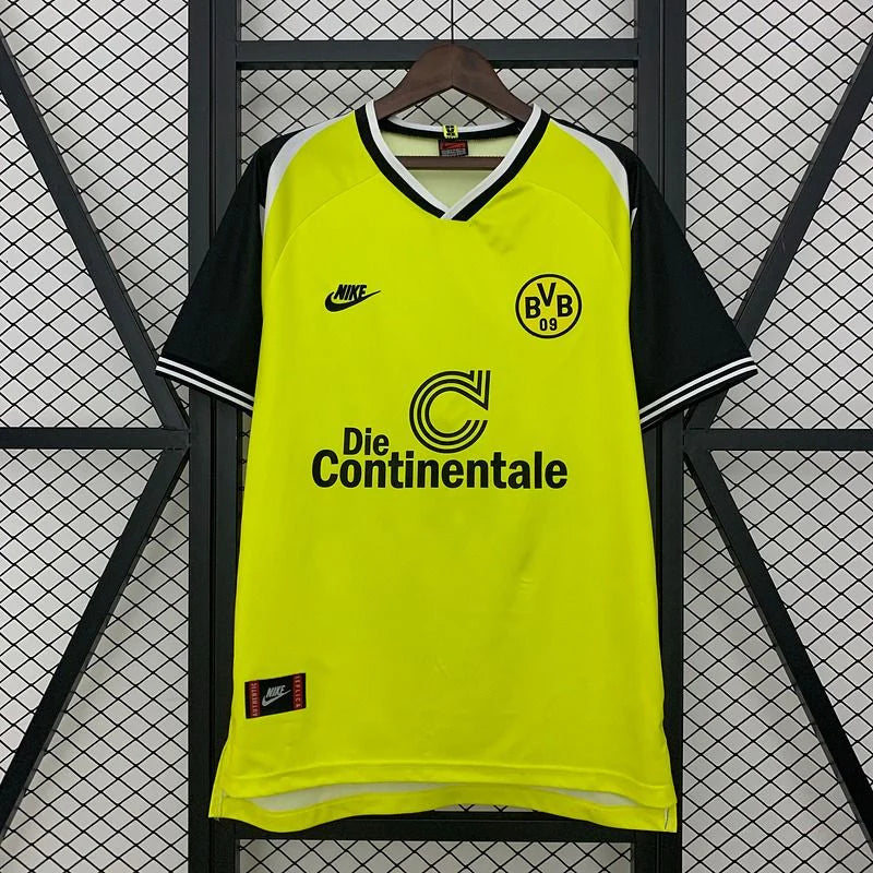 Borussia Dortmund retro home jersey, front view with a bright yellow body, black short sleeves, BVB 09 crest and Die Continentale sponsor.
