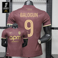 AS Monaco burgundy short-sleeve jersey, front and back views with gold BALOGUN 9 print, tonal pattern and APM Monaco sponsor, alongside a Ligue 1 graphic.
