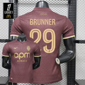AS Monaco burgundy jersey shown from the front and back, with gold BRUNNER 29 print, short sleeves, tonal pattern and APM Monaco sponsor.
