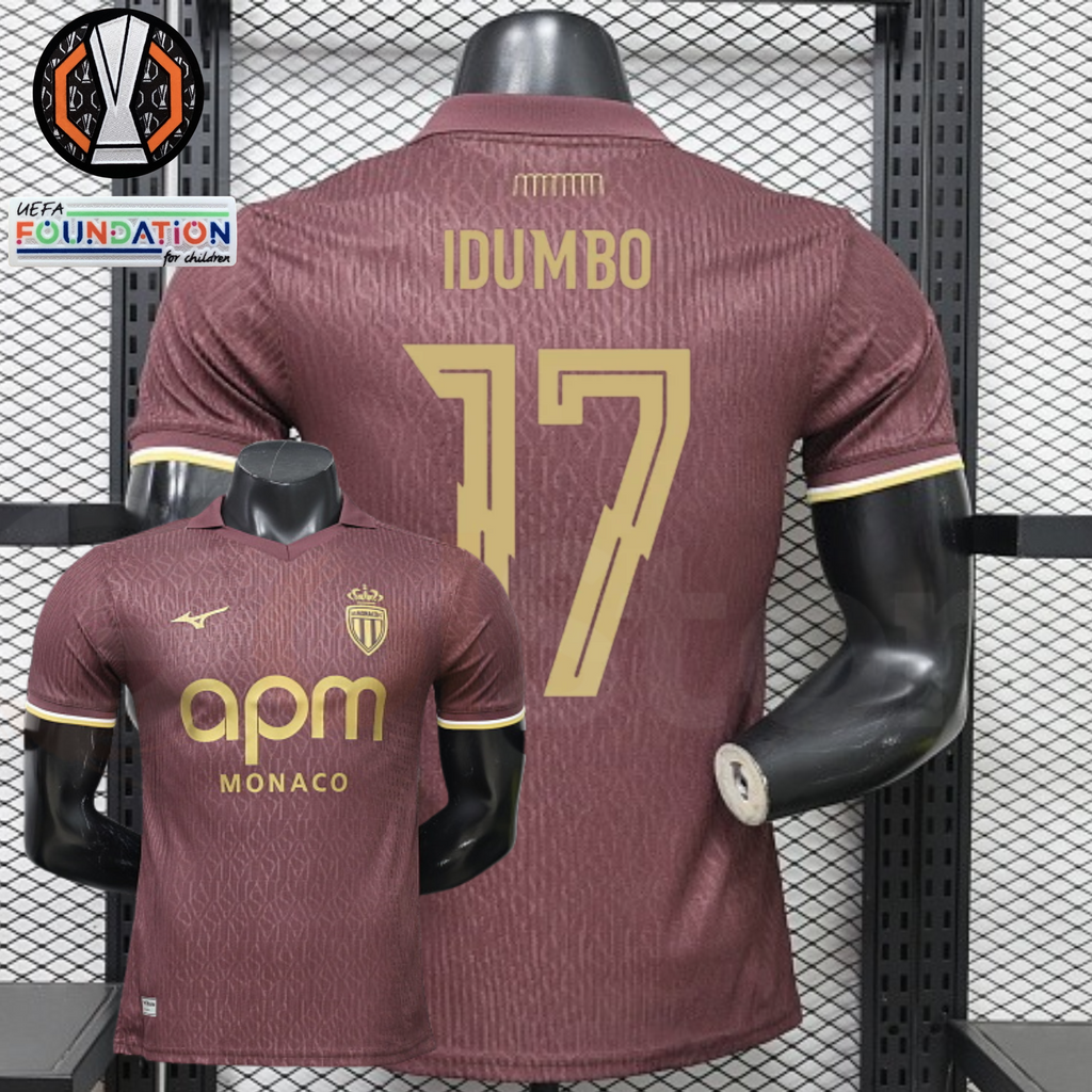 AS Monaco burgundy short-sleeve jersey, front and back views with gold IDUMBO 17 print, tonal pattern and APM Monaco sponsor, alongside Europa League graphics.
