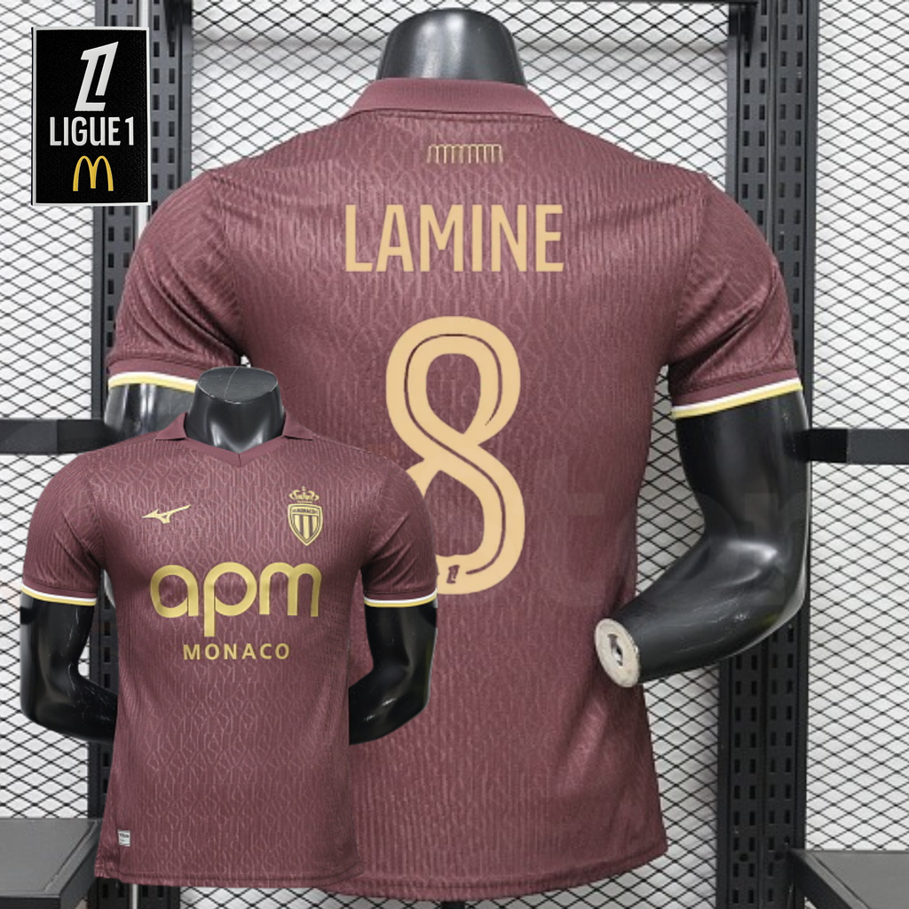 AS Monaco burgundy short-sleeve jersey shown from the front and back, with gold LAMINE 8 print, tonal pattern and APM Monaco sponsor, alongside a Ligue 1 graphic.
