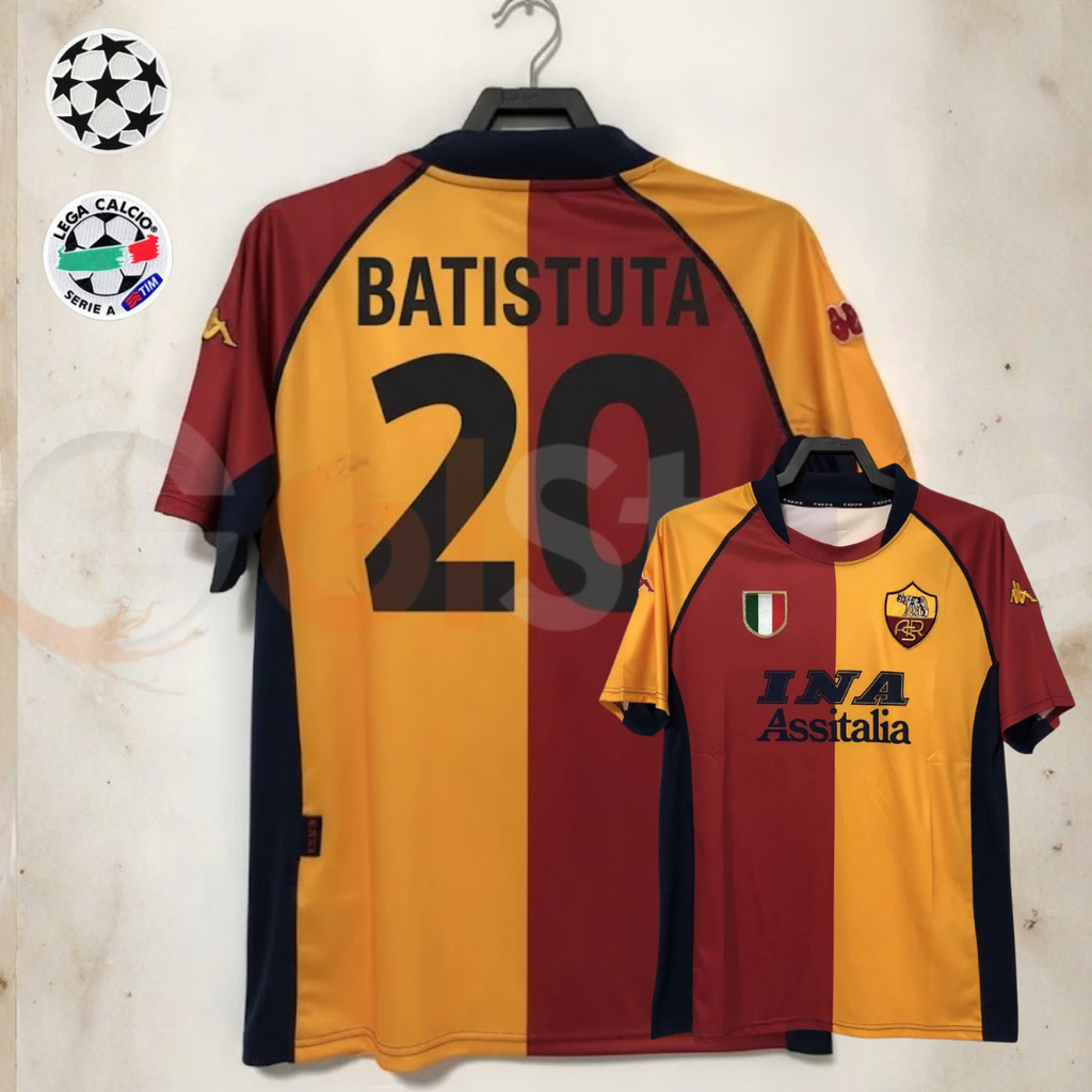 Front and back views of a burgundy and gold AS Roma short-sleeve retro jersey with black Batistuta number 20 print and INA Assitalia sponsor, alongside UCL and Serie A badge graphics.