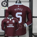 Front and back views of a claret Aston Villa long-sleeve jersey with a light blue collar, light blue Mings number 5 print and Visit Rwanda sponsor.