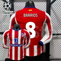  Front and back views of a red and white Atlético Madrid long-sleeve jersey with blue trim, white Barrios number 8 print and Riyadh Air sponsor, alongside UCL graphics.