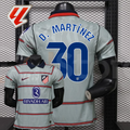 Front and back views of a light grey Atlético Madrid short-sleeve jersey with red horizontal stripes, blue D. Martínez number 30 print and Riyadh Air sponsor, alongside a LaLiga graphic.