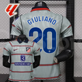 Front and back views of a light grey Atlético Madrid short-sleeve jersey with red horizontal stripes, blue Giuliano number 20 print and Riyadh Air sponsor, alongside a LaLiga graphic.