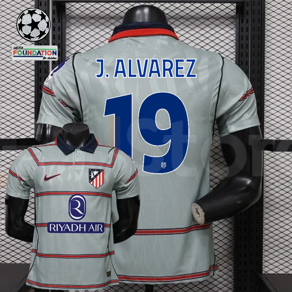 Front and back views of a light grey Atlético Madrid short-sleeve jersey with red horizontal stripes, blue J. Alvarez number 19 print and Riyadh Air sponsor, alongside UCL graphics.