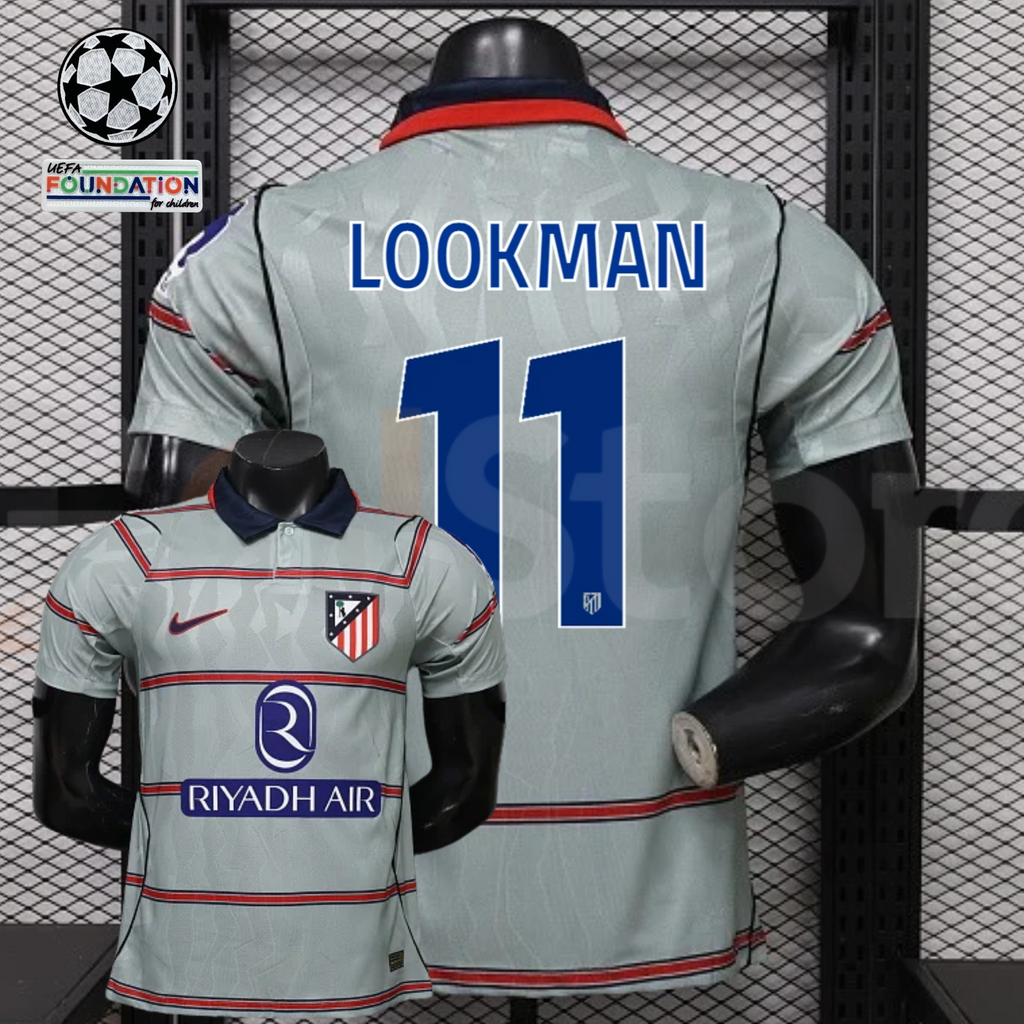 Front and back views of a light grey Atlético Madrid short-sleeve jersey with red horizontal stripes, blue Lookman number 11 print and Riyadh Air sponsor, alongside UCL graphics.