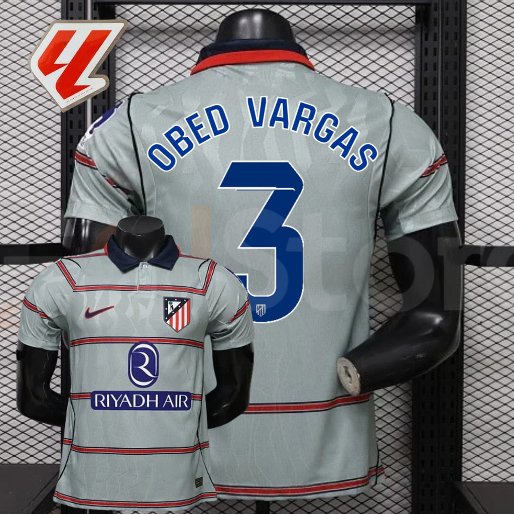 Front and back views of a light grey Atlético Madrid short-sleeve jersey with red horizontal stripes, blue Obed Vargas number 3 print and Riyadh Air sponsor, alongside a LaLiga graphic.