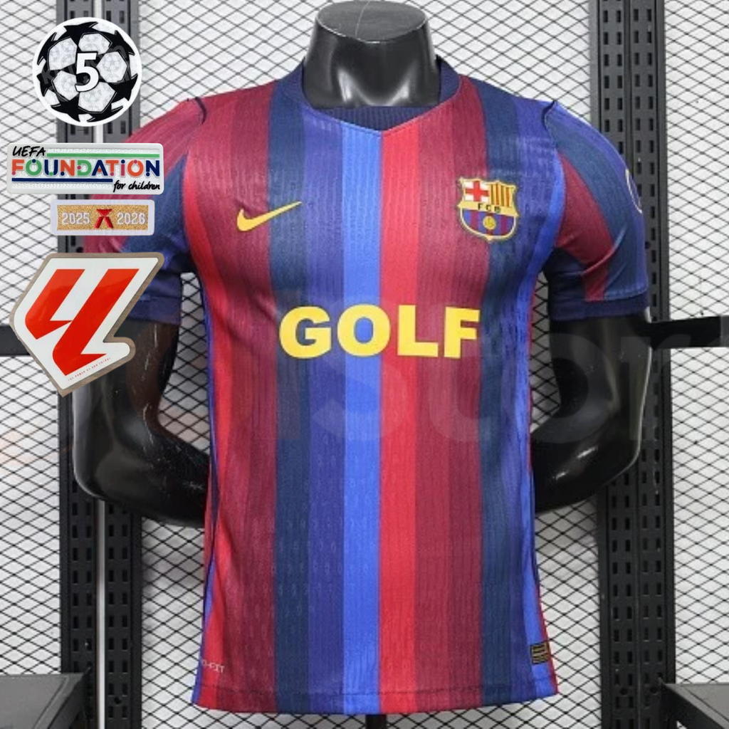 Front view of a red and blue striped Barcelona short-sleeve jersey with yellow GOLF sponsor lettering, club crest and Nike logo, alongside UCL and LaLiga graphics.