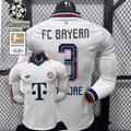  Front and back views of a white Bayern Munich long-sleeve jersey with a dark collar, red and dark detailing and Minjae number 3 print, alongside UCL and Bundesliga patch graphics.
