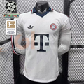 Front view of a white Bayern Munich long-sleeve jersey with a dark collar, red and dark sleeve stripes, club crest and large Telekom sponsor, alongside UCL and Bundesliga patch graphics.