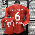  Front and back views of a red Bayern Munich long-sleeve home jersey with tonal stripes, white Kimmich number 6 print and Telekom sponsor, alongside UCL and Bundesliga badge graphics.