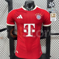 Red Bayern Munich home jersey, front view, with short sleeves, white trim and club crest.