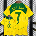 Front and back views of a yellow Brazil retro short-sleeve home jersey with green trim, yellow Adriano lettering on a green upper back panel and green number 7 print.