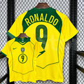 Front and back views of a yellow Brazil retro short-sleeve home jersey with green trim, yellow Ronaldo lettering on a green upper back panel and green number 9 print.