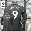 Chelsea dark grey long-sleeve jersey shown from the front and back, with white JOÃO PEDRO 9 print, neon yellow details and a gold FIFA World Champions chest badge.
