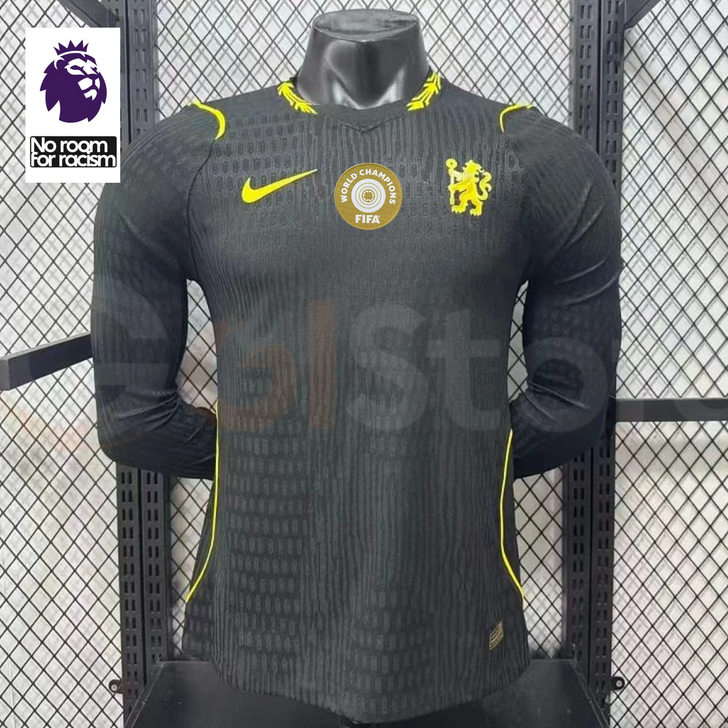 Chelsea dark grey long-sleeve jersey with neon yellow crest and Nike logo, tonal pattern and gold FIFA World Champions chest badge, alongside a Premier League graphic.
