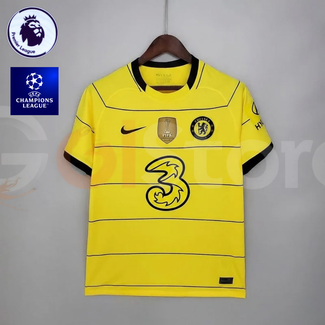  Front view of a yellow Chelsea FC 2021–2022 short-sleeve away jersey with thin black horizontal stripes, black collar and sleeve trim, and a gold FIFA chest badge.