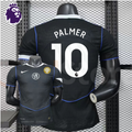  Front and back views of a black Chelsea FC short-sleeve third jersey with blue piping, white Palmer number 10 print and a gold FIFA World Champions chest badge.