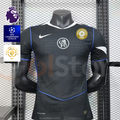 Front view of a black Chelsea FC short-sleeve third jersey with blue piping, white collar trim, central Chelsea crest and gold FIFA World Champions badge.