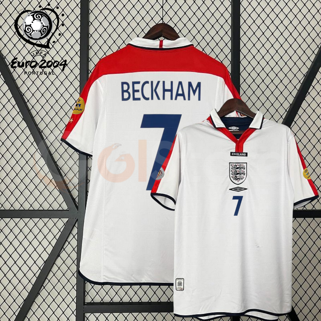 Front and back views of a white England short-sleeve retro jersey with red shoulder panels, dark blue Beckham number 7 print and sleeve patches, alongside a EURO 2004 graphic.