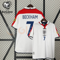 Front and back views of a white England short-sleeve retro jersey with red shoulder panels, dark blue Beckham number 7 print and sleeve patches, alongside a EURO 2004 graphic.