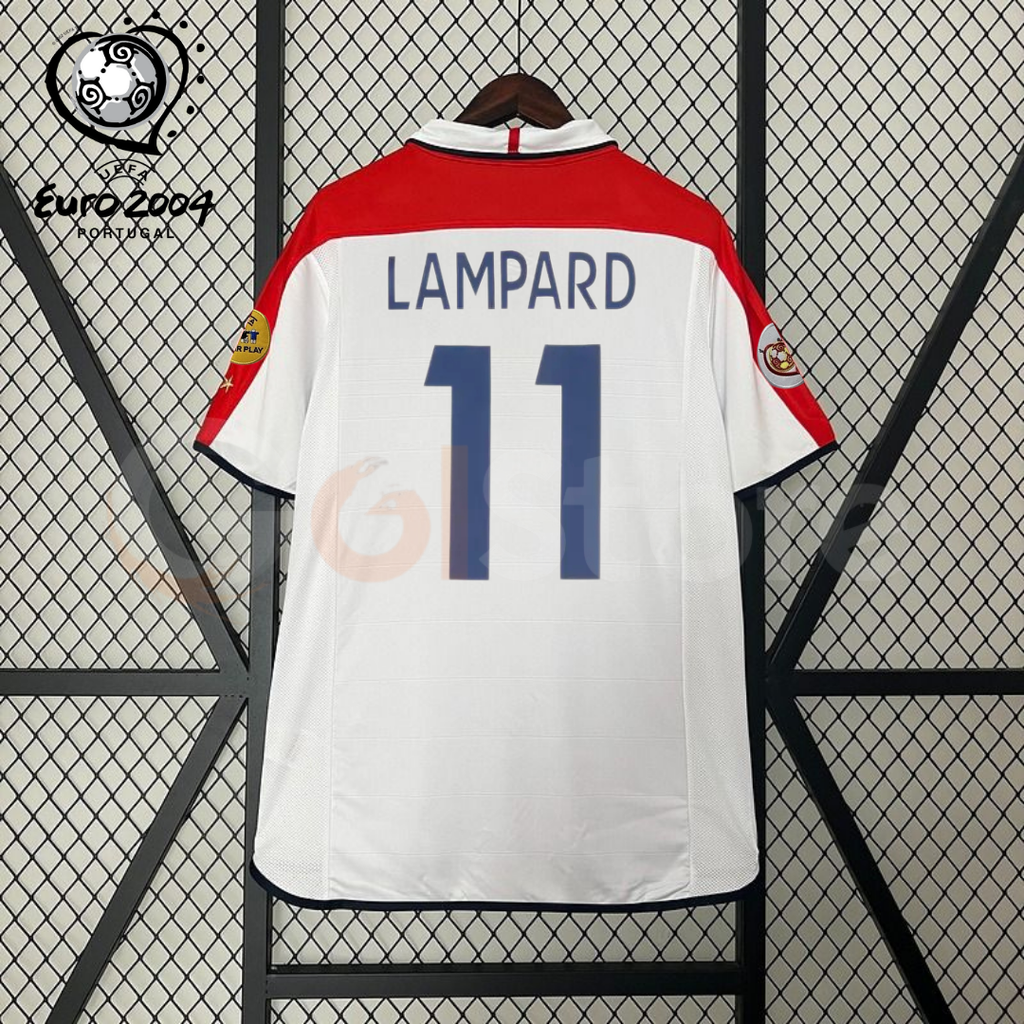 Back view of a white England short-sleeve retro jersey with red shoulder panels, dark blue Lampard number 11 print and sleeve patches, alongside a EURO 2004 graphic.