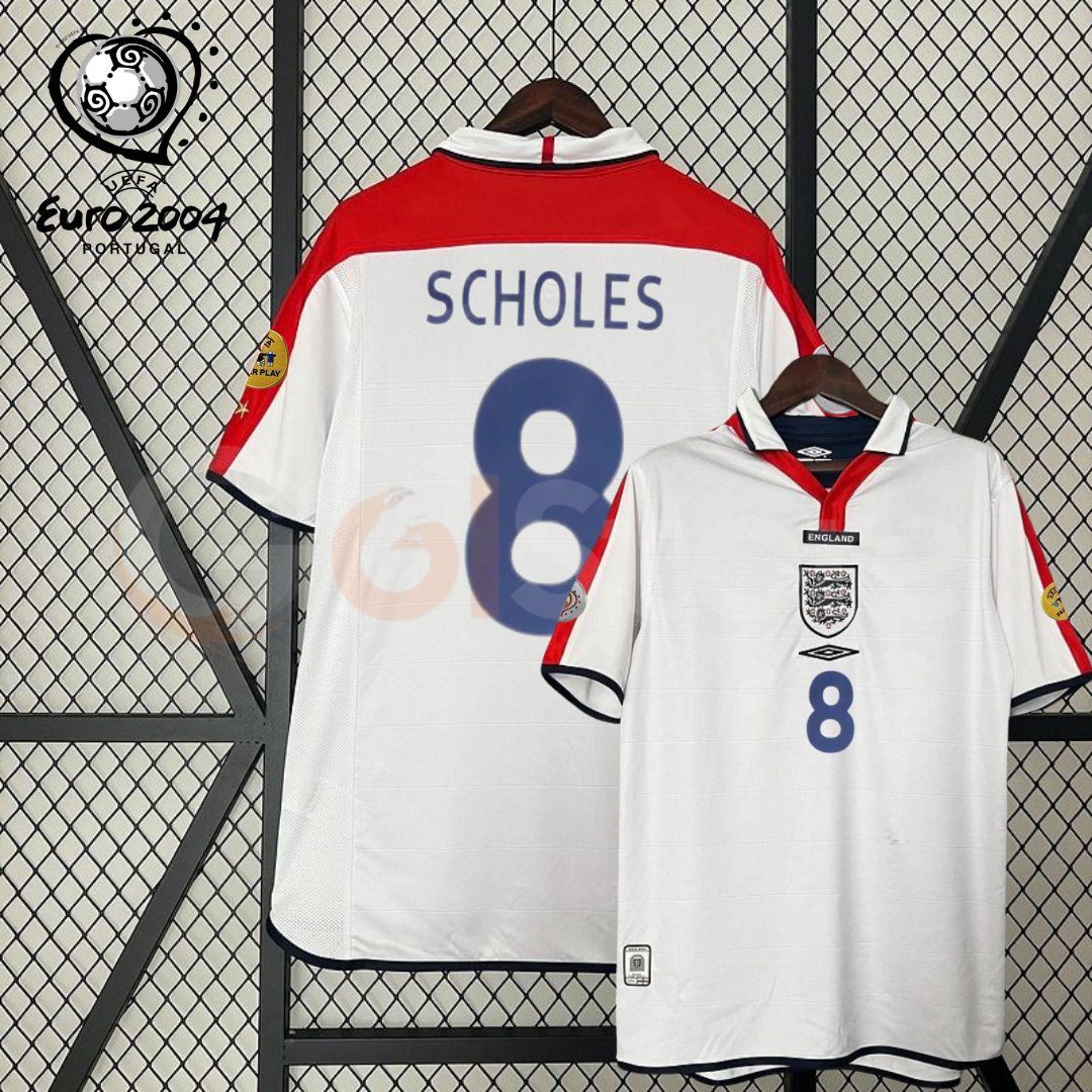Front and back views of a white England short-sleeve retro jersey with red shoulder panels, dark blue Scholes number 8 print and sleeve patches, alongside a EURO 2004 graphic.