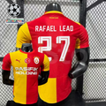 Front and back views of a red and yellow Galatasaray short-sleeve home jersey with white Rafael Leao number 27 print and Pasifik Holding sponsor.