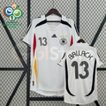 Front and back views of a white Germany 2006 retro short-sleeve home jersey with black, red and gold details, Ballack number 13 print and World Cup sleeve patches.