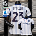  Front and back views of a white Inter Milan short-sleeve jersey with blue pinstripes, navy Barella number 23 print and Betsson Sport sponsor, alongside UCL and Serie A graphics.