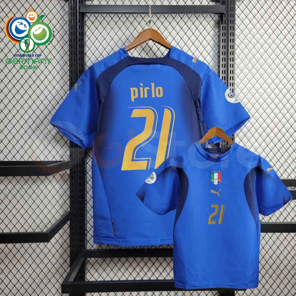 Front and back views of a blue Italy short-sleeve retro home jersey with dark panels, gold Pirlo number 21 print and sleeve patches, alongside a Germany 2006 World Cup graphic.