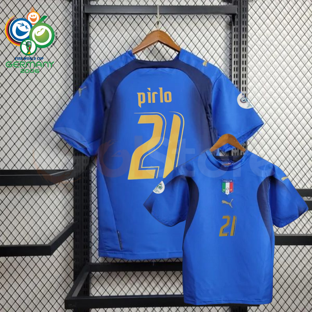 Front and back views of a blue Italy short-sleeve retro home jersey with dark panels, gold Pirlo number 21 print and sleeve patches, alongside a Germany 2006 World Cup graphic.
