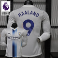 Front and back views of a white Manchester City long-sleeve jersey with blue central stripes and Haaland number 9 print, alongside a Premier League graphic.