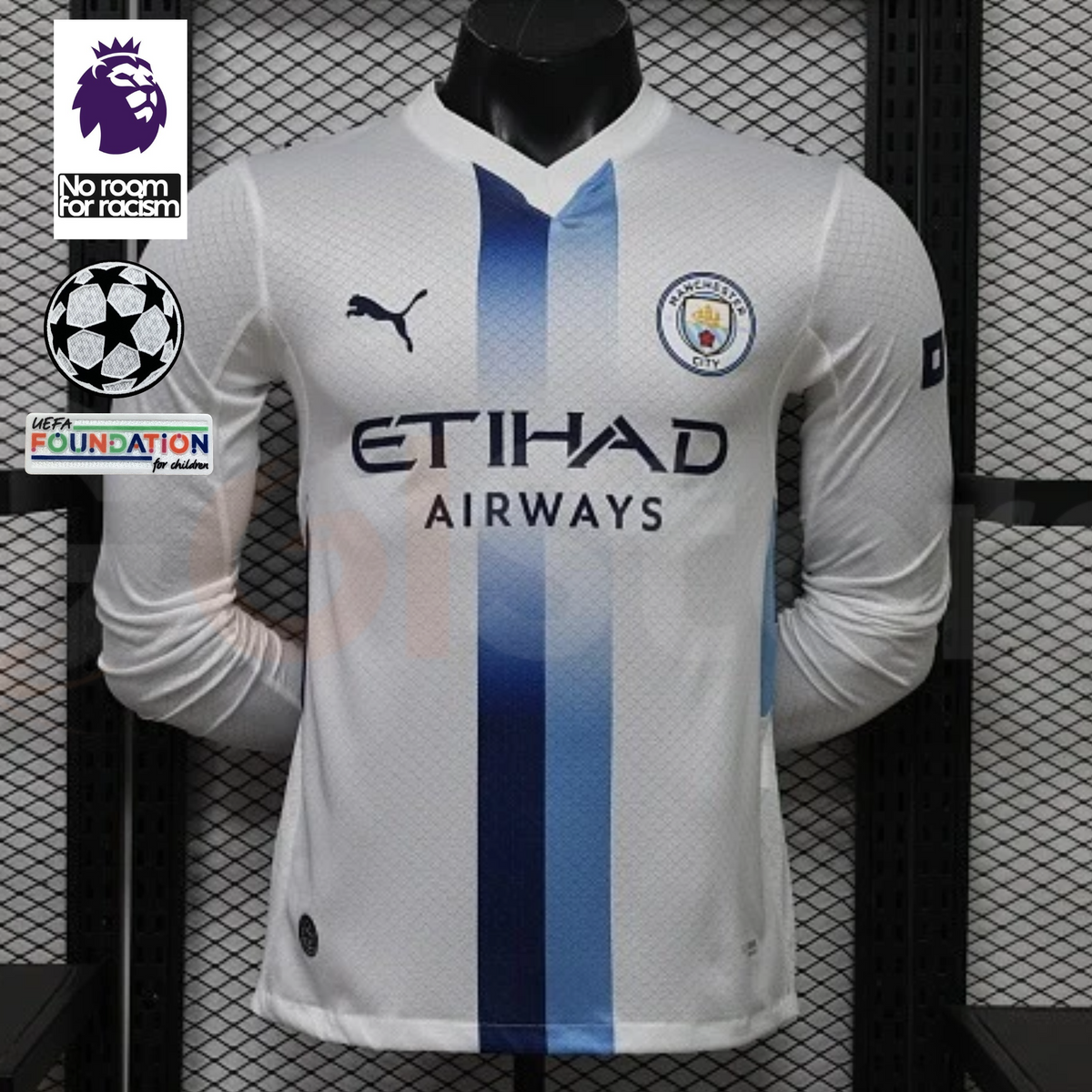 Front view of a white Manchester City long-sleeve jersey with blue central stripes, club crest, Puma logo and Etihad Airways sponsor, alongside Premier League and UCL graphics.