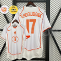 Front and back views of a white Netherlands 2004 away retro short-sleeve jersey with orange trim, V. Hooijdonk number 17 print, and EURO and UEFA Fair Play graphics.