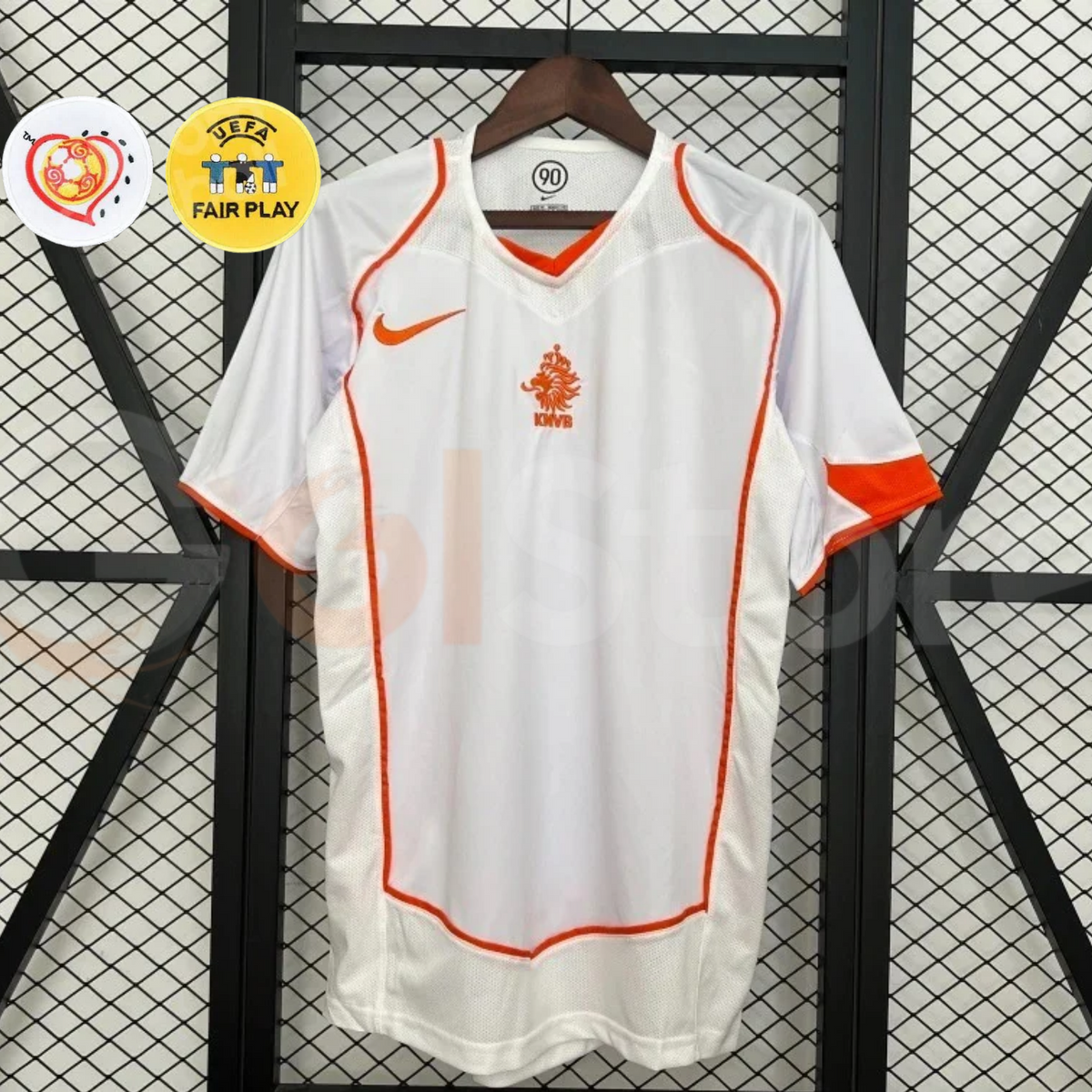 Front view of a white Netherlands 2004 away retro short-sleeve jersey with orange piping, an orange crest and Nike logo, alongside EURO and UEFA Fair Play graphics.