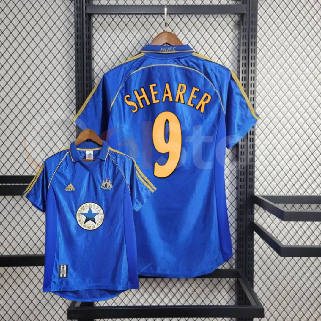 Front and back views of a blue Newcastle United short-sleeve retro away jersey with yellow shoulder stripes, Shearer number 9 print and Newcastle Brown Ale sponsor.