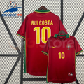  Front and back views of a red Portugal retro short-sleeve home jersey with green and yellow trim, yellow Rui Costa number 10 print and Portugal crest.