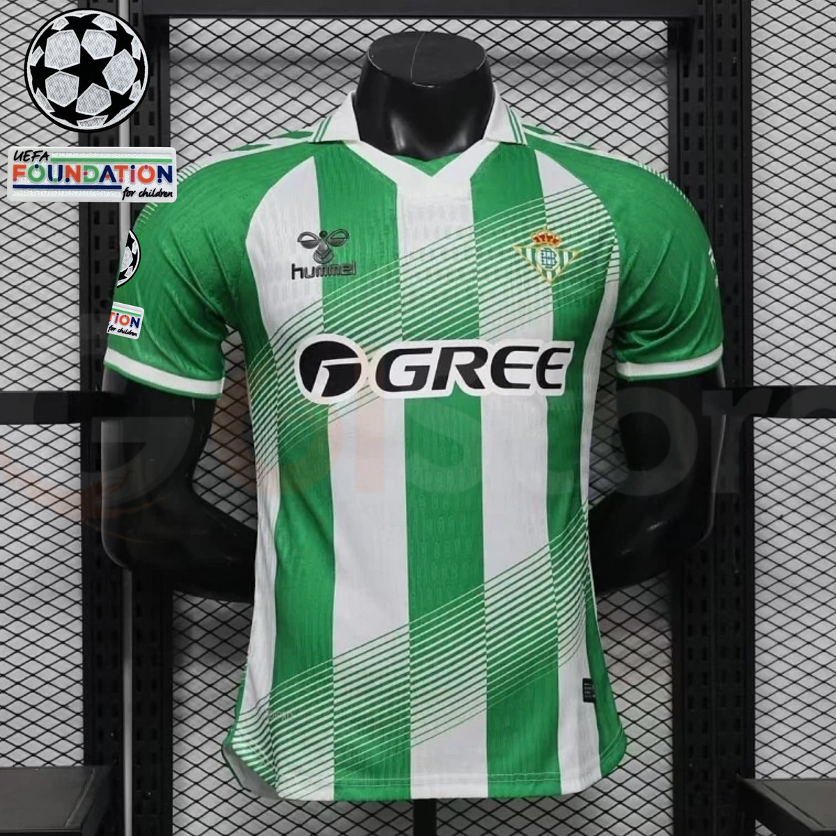Real Betis green and white striped short-sleeve jersey with diagonal line details, a white collar, GREE sponsor and Champions League and UEFA Foundation sleeve patches.
