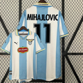 SS Lazio retro jersey shown from the front and back, with sky-blue and white stripes, black MIHAJLOVIC 11 print, short sleeves, Lazio crest and Del Monte sponsor.
