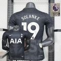 Front and back views of a black Tottenham Hotspur short-sleeve jersey with a subtle grid pattern, white Solanke number 19 print, white club crest and AIA sponsor.