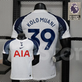 Front and back views of a white Tottenham Hotspur short-sleeve home jersey with navy and grey sleeves, navy Kolo Muani number 39 print and red AIA sponsor.