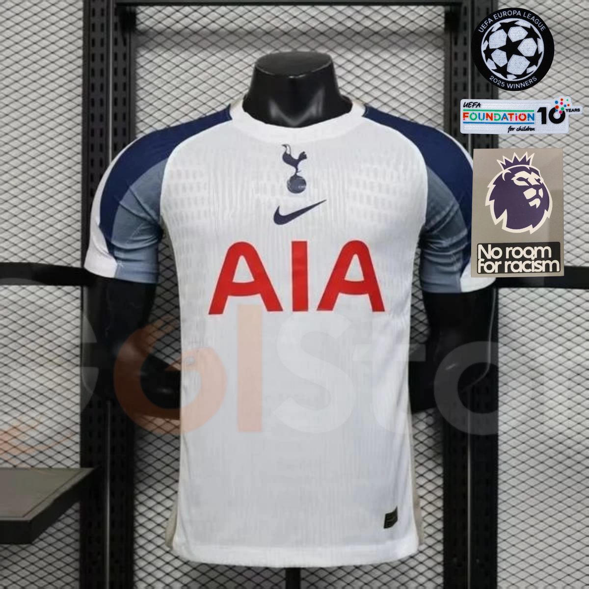 Front view of a white Tottenham Hotspur short-sleeve home jersey with navy and grey sleeves, a central club crest and red AIA sponsor.